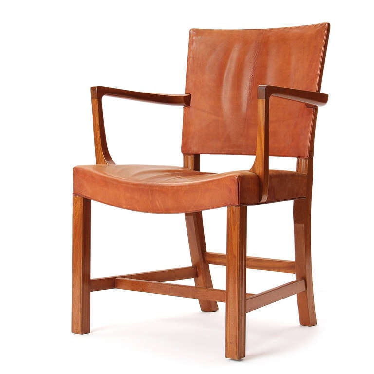 A pair of Scandinavian Modern dining armchairs designed by Kaare Klint. These chairs feature Cuban mahogany frames and the original natural leather upholstery. Manufactured by Rud Rasmussen in Denmark, circa 1940s.