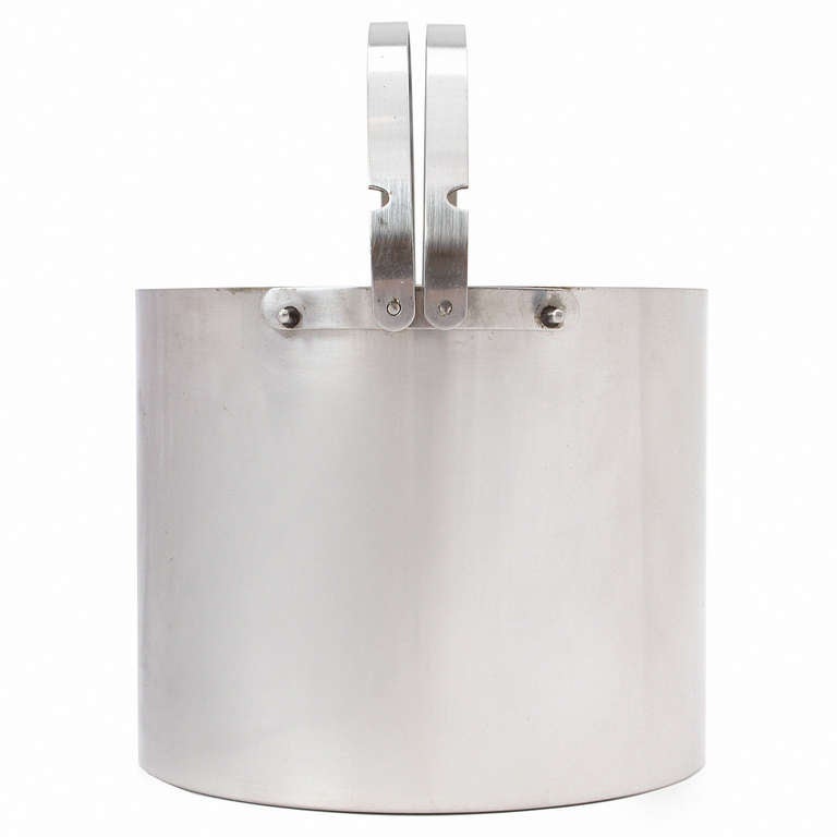 A precision crafted and elegant double walled brushed stainless steel ice bucket with folding handles from Arne Jacobsen's seminal Cylinda collection of 1967.