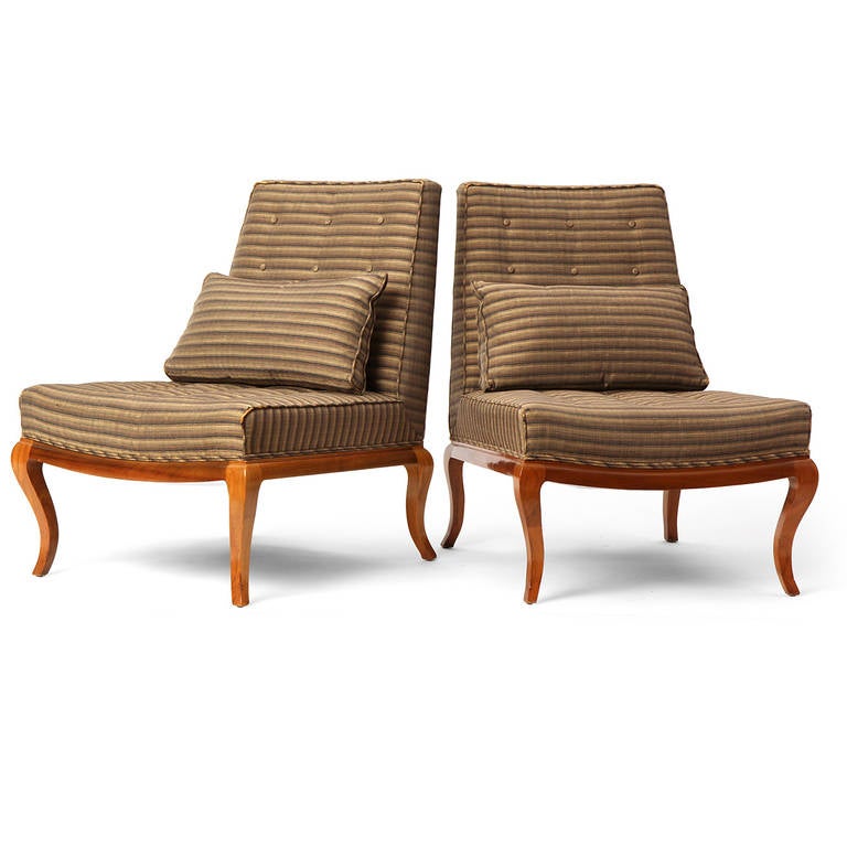 A pair of well-scaled and beautifully proportioned button tufted slipper chairs having striated upholstery and resting on exposed walnut frames with distinctive cabriole legs.