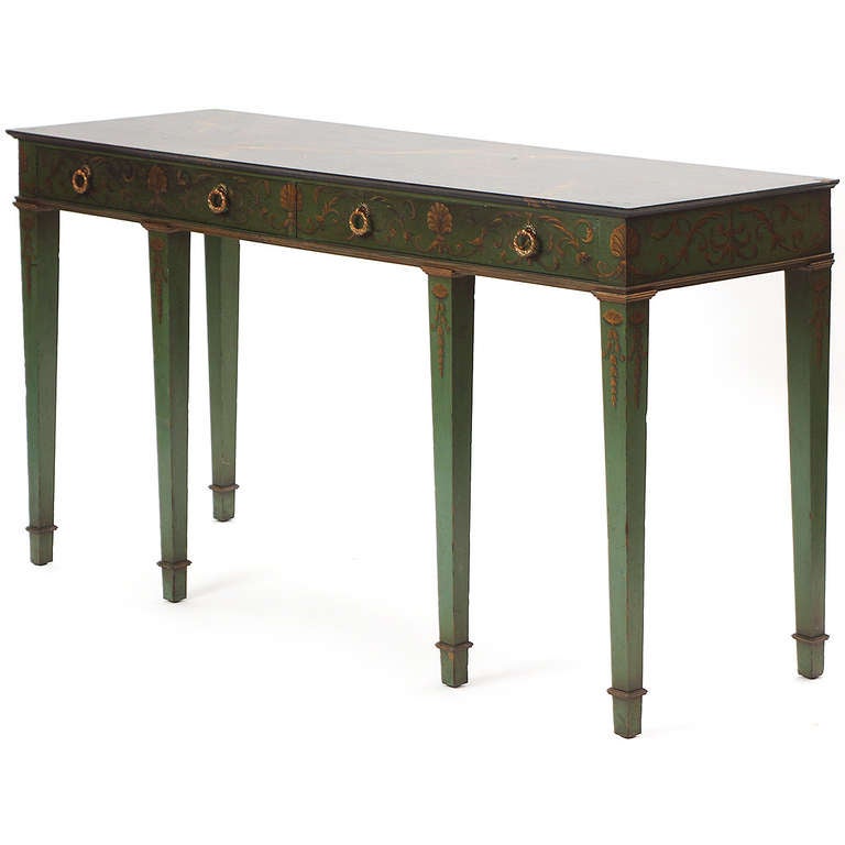 A custom made narrow console or hall table having six tapered legs, bronze drawer pulls and fine green and gold applied decoration.