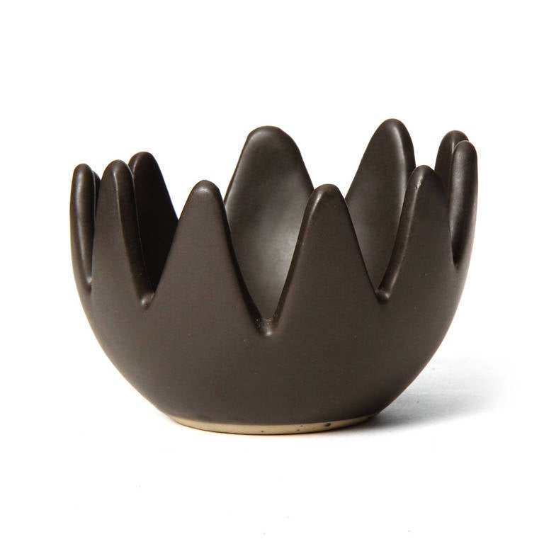 A masterfully rendered small bowl having a a continuous deeply scalloped edge and a rich and soft matte dark brown glaze.