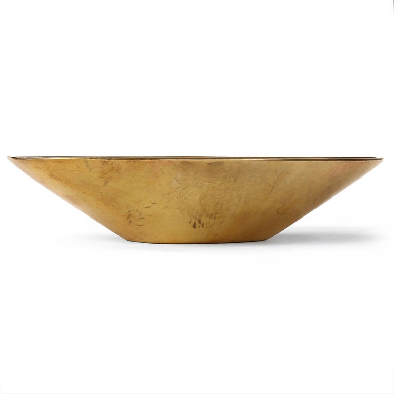 An impeccably crafted patinated bronze bowl of oblong, flaring form.