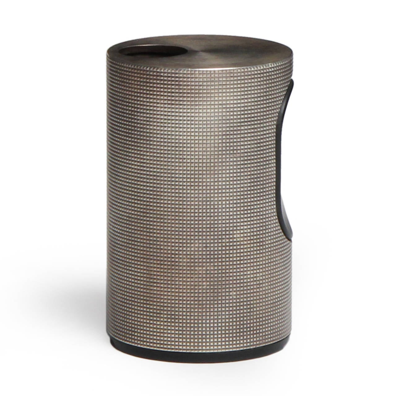 A refined and geometric steel table lighter having a precise cylindrical form with incised cross hatching.