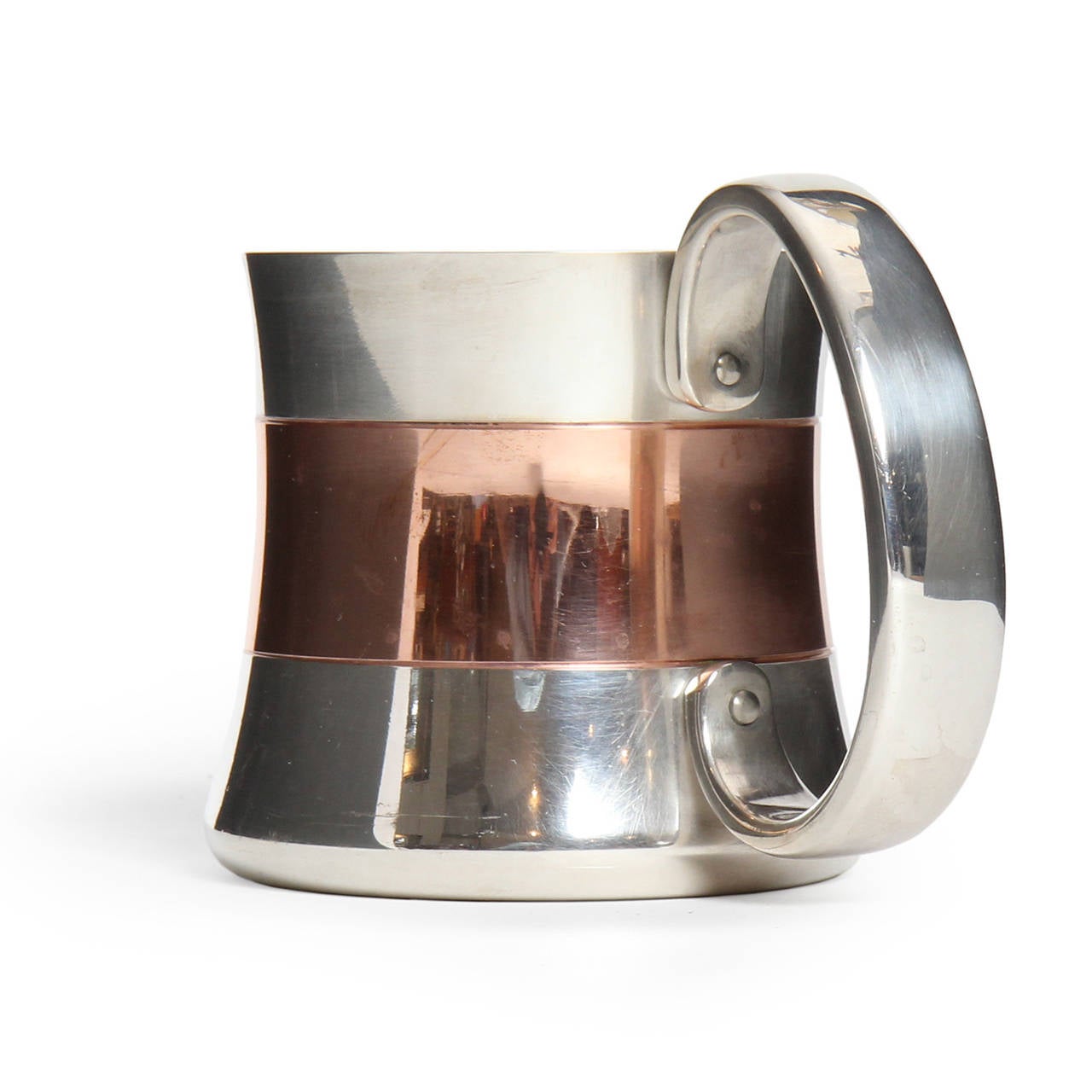 A fine silver plated beer mug of corseted form having a central copper band and a generous sculptural handle.