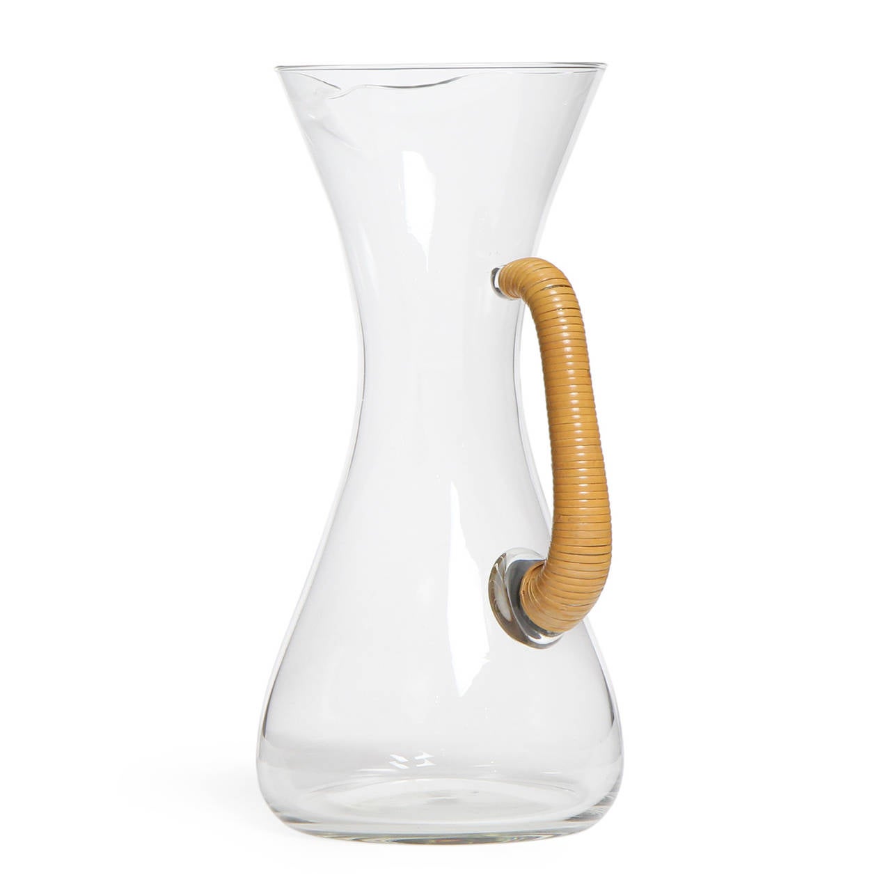 A finely crafted blown glass pitcher having organic rounded lines and beautiful cane wrapped handle.