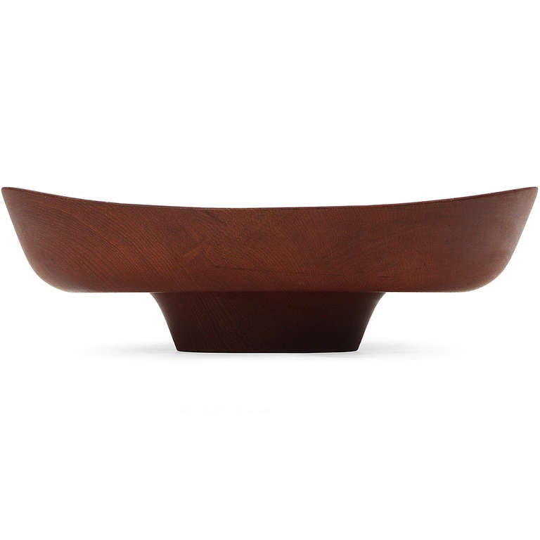 Truly a work of art - a rare and sensuous footed centerpiece bowl sculpted from a single block of rich teak , designed by Finn Juhl and executed by Kay Bojesen.