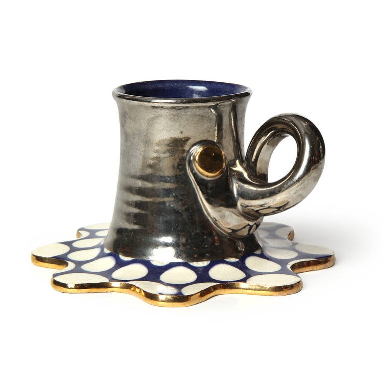 A wonderfully expressive and masterfully executed hand-thrown unique ceramic Funk-movement sculpture, the cup and elephant-head handle having an iridescent gun metal glaze and the apostrophe-shaped base is covered with glazed polka dots.