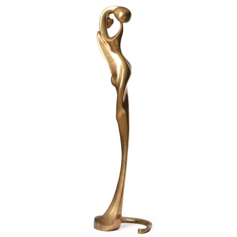 A dramatic and beautifully rendered floor sculpture in warmly patinated bronze depicting an undulating abstracted female form, titled 