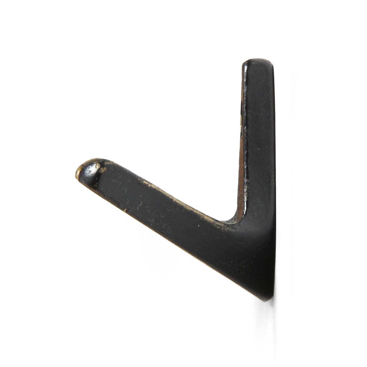 A sculptural modernist wall mounted coat hook well crafted of patinated bronze.