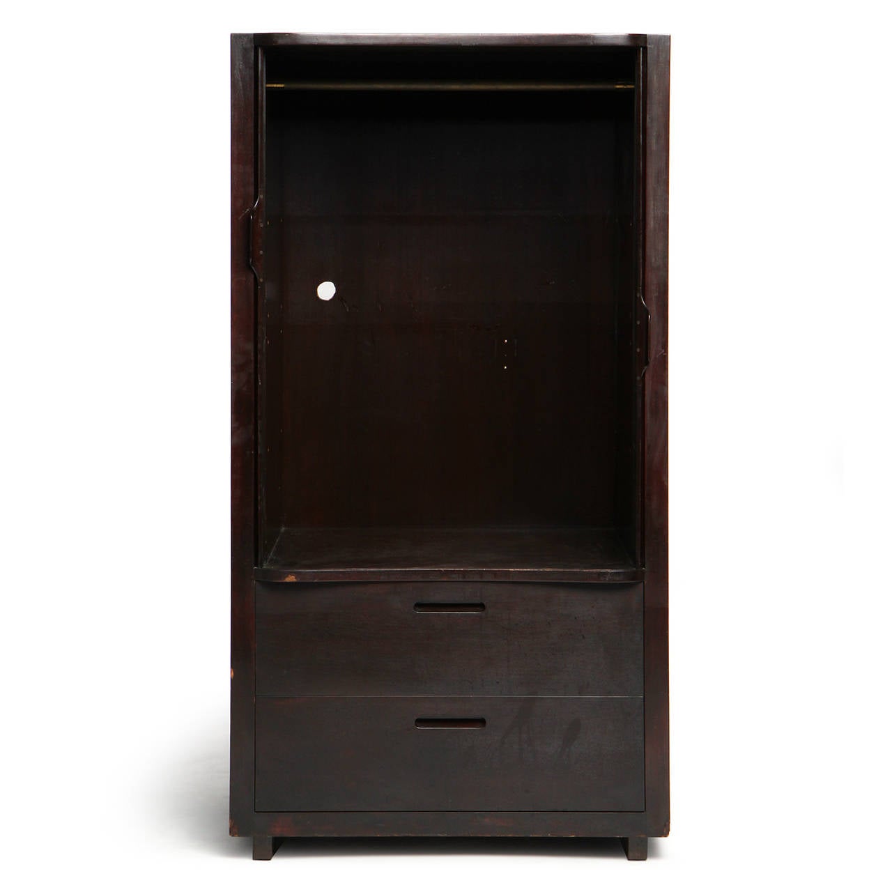 A simple and refined ebonized mahogany wardrobe having tambour doors with integrated handles a top two (2) drawers with cut out handles.