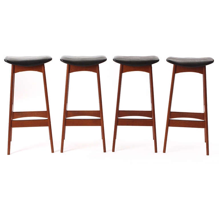 A finely constructed and tailored set of stools having solid teak frames and sculptural seats.