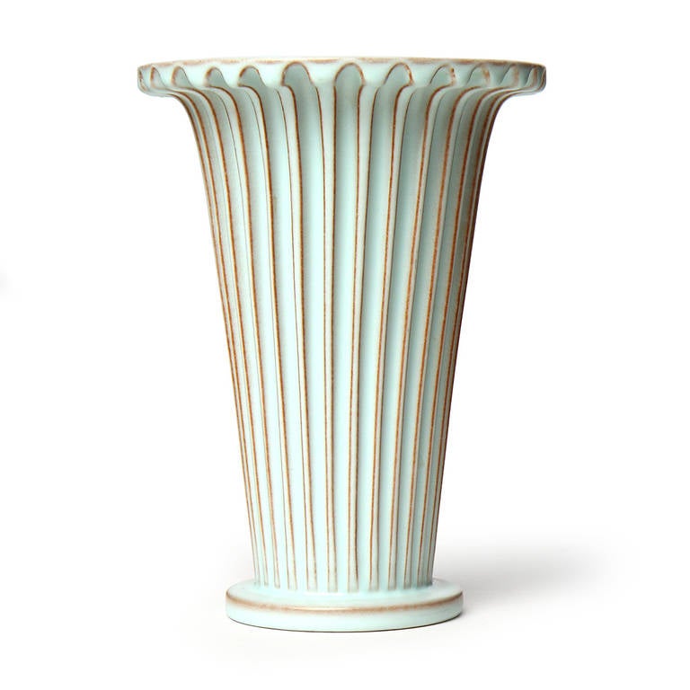 A striking and finely rendered trumpet-form vase having fluted channels and a rich, milky robins-egg glaze with natural slip accents.