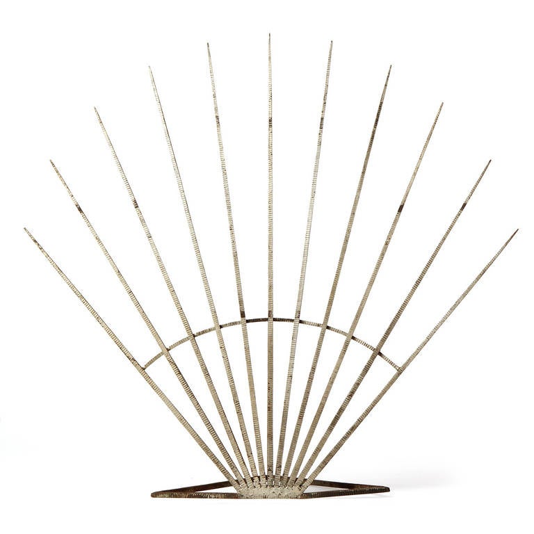 A unique and expressive Art Deco fire screen handmade of silver enameled scored steel and having a fan form.