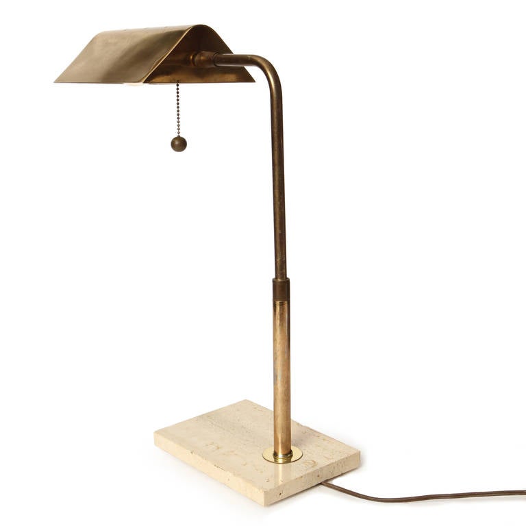 An elegant adjustable brass desk lamp having a rectangular marble base supporting a swiveling stem and pivoting tent shade.