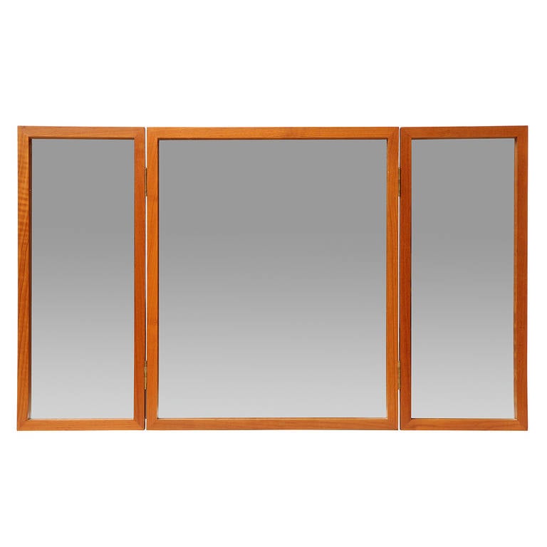 An impeccably crafted Scandinavian Modern vanity mirror in a rich teak wood frame. The piece is a folding tabletop vanity but can also be wall-mounted. Made in Denmark, circa 1960s.