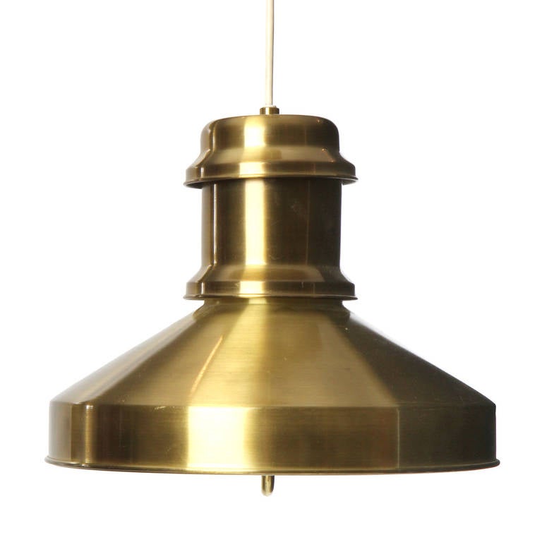 A Scandinavian Modern pendant lamp / fixture in a sculptural and finely crafted lacquered brass chandelier with a well-defined ceiling mount.