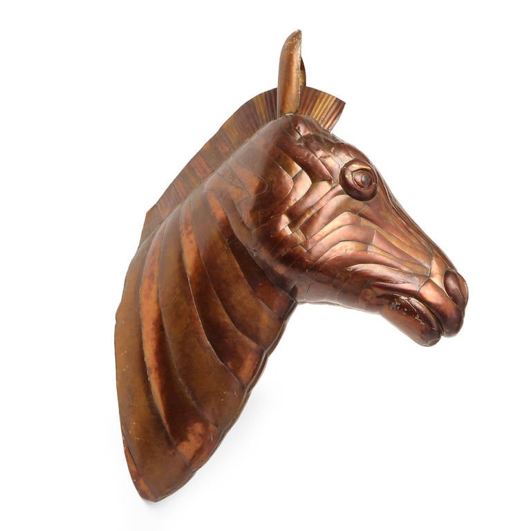 A wonderfully expressive life-sized unique sculpture of a zebra's head, rendered in copper and brass.