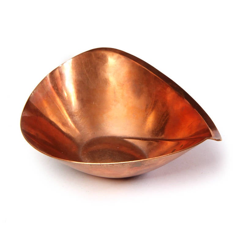 An impeccably crafted sculptural small bowl having a bold asymmetrical form and rendered in warmly patinated copper.