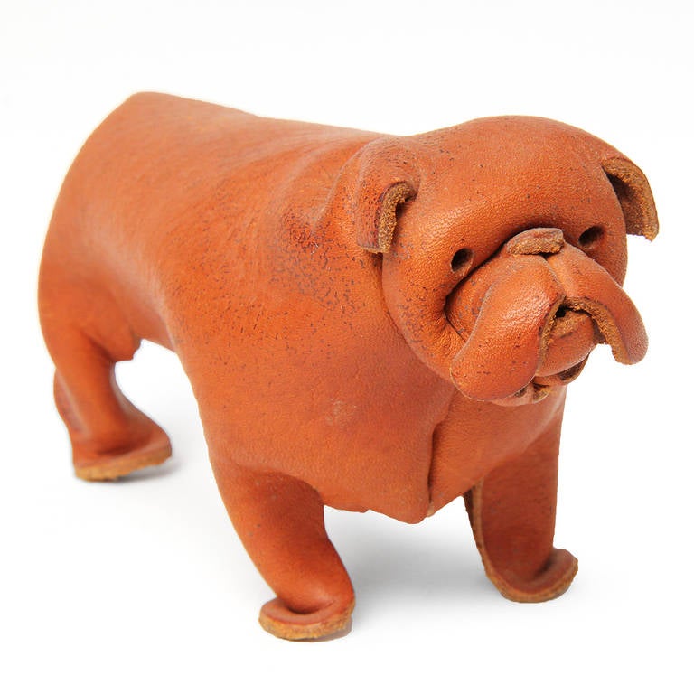 A delightful and expressive bulldog masterfully formed from a single sheet of folded, pinched, pressed and cut natural leather.