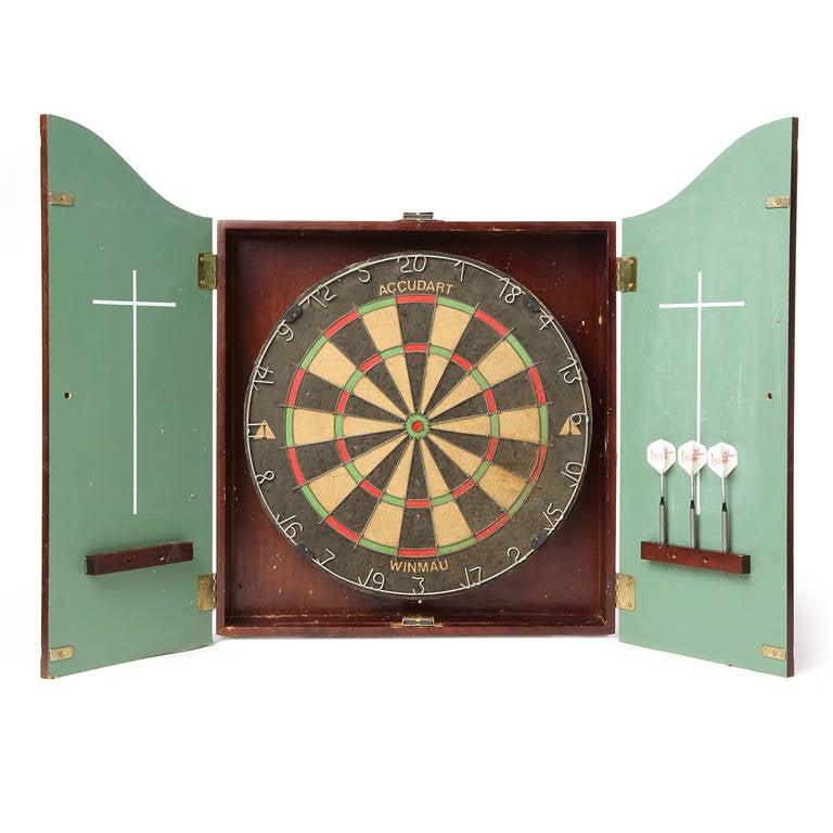 A dart board set that includes a self healing dart board and steel tipped darts housed in a well-constructed wall-mounted walnut case.