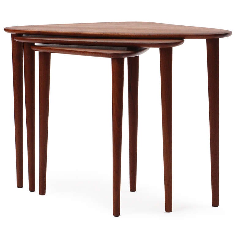 A good set of nesting tables in solid teak of descending scale and height; each with a rounded triangular top and three turned legs.

All with floral makers mark.
Small: 16