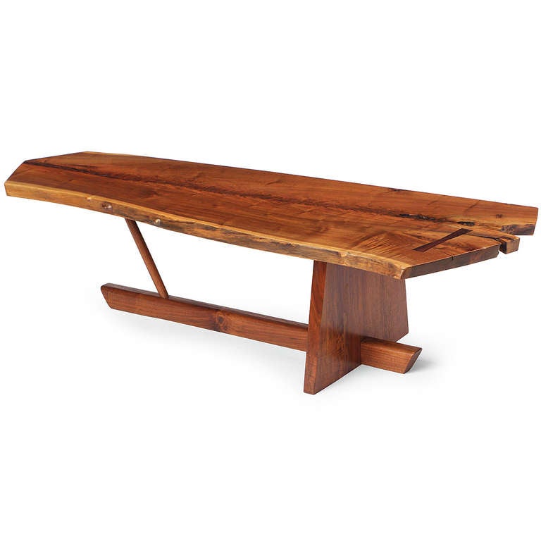 An excellent and sculptural Minguren low table by George Nakashima having a highly figured single slab free-edged black walnut top with a rosewood butterfly floating on a dramatic and architectural base, in fine original condition.