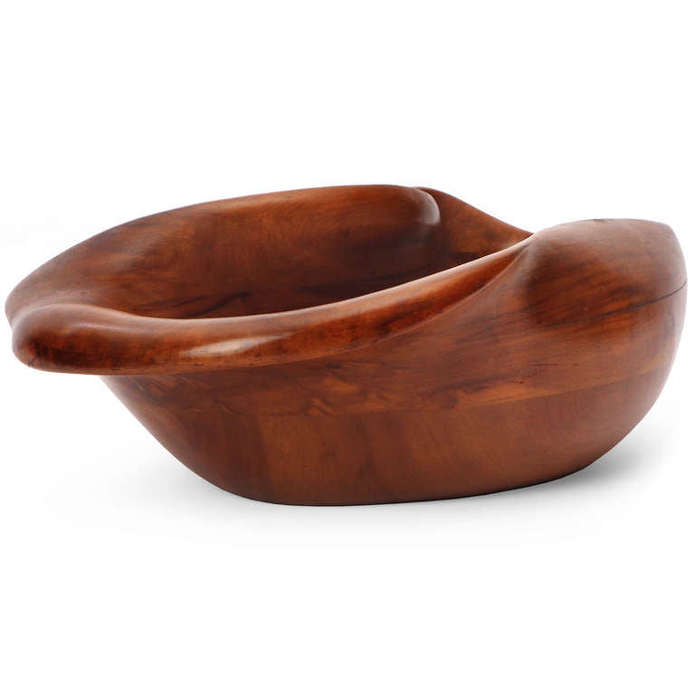 A rare and voluptuous hand-carved biomorphic bowl in claro walnut from Russel Wright's 