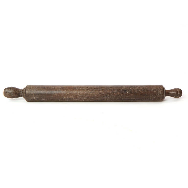 A beautifully patinated and well scaled hand-turned oak rolling pin.
