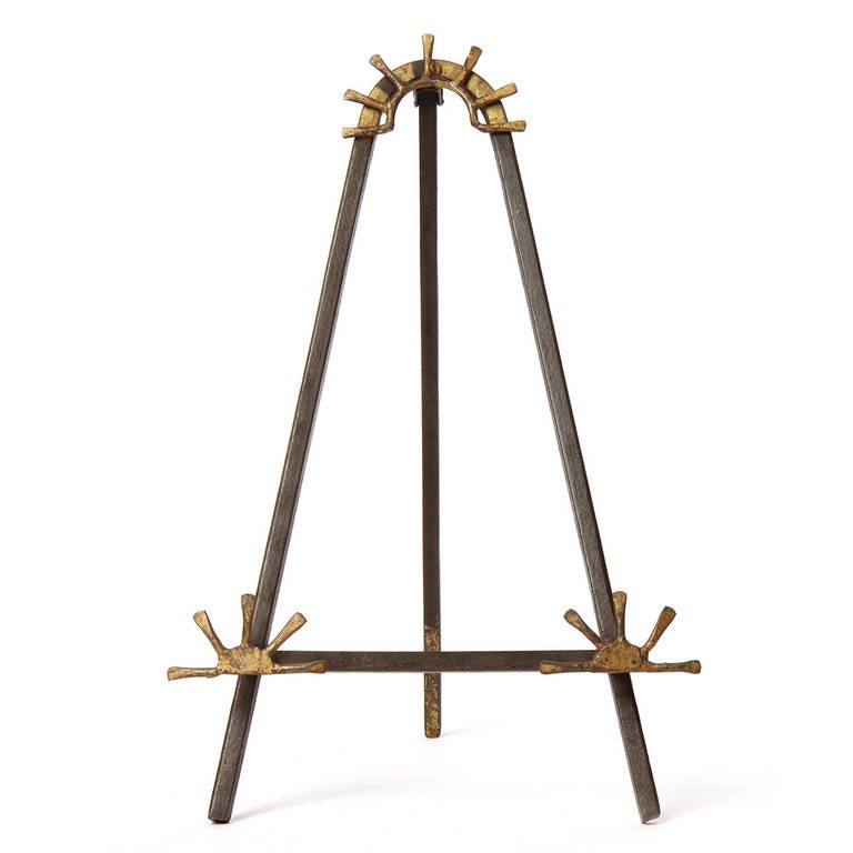 A delightful and expressive hand-wrought small-scaled easel formed of square-gauge iron with gilded iron sunburst-shaped embellishment.