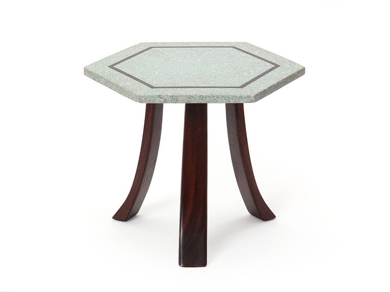 An end table with bronze-inlaid pale blue hexagonal terrazzo tops and polished dark mahogany swag legs.