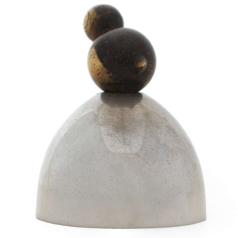 An Art Deco hand bell by Walter von Nessen for Chase having a stylized abstracted bronze bird perched atop a nickeled steel dome.