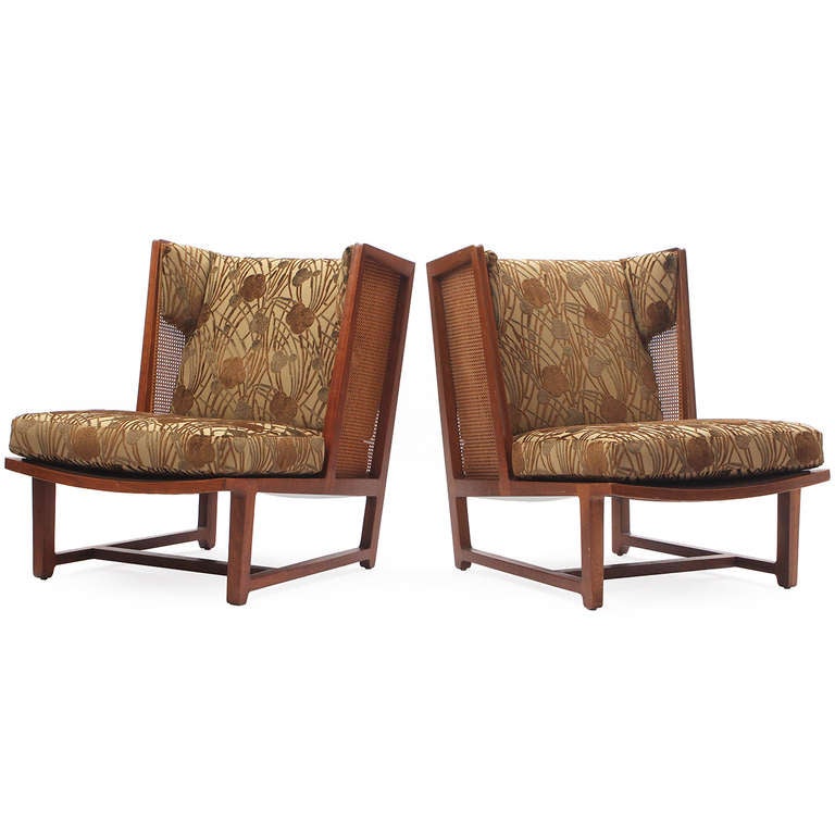 A fine and rare pair of wing chairs by Edward Wormley for Dunbar in walnut and cane having generous and low proportions and beautiful cut velvet floral Japonesque Larsen upholstery.