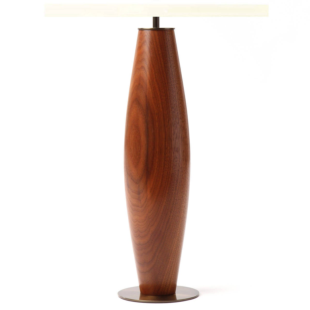 A table lamp turned from a solid piece of vividly grained teak. The base is 19.5