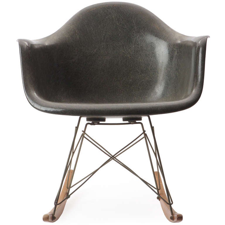 The iconic rocker: Zenith Shell Rocking Chair RAR designed by Charles and Ray Eames featuring the iconic organically shaped fiberglass shell resting on cross-braced steel struts that are attached to birch runners. Made by Herman Miller, circa 1960s.