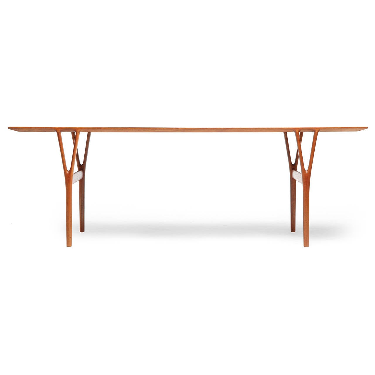 A refined and sculptural Scandinavian Modern low table by Helge Vestergaard-Jensen featuring a spare 