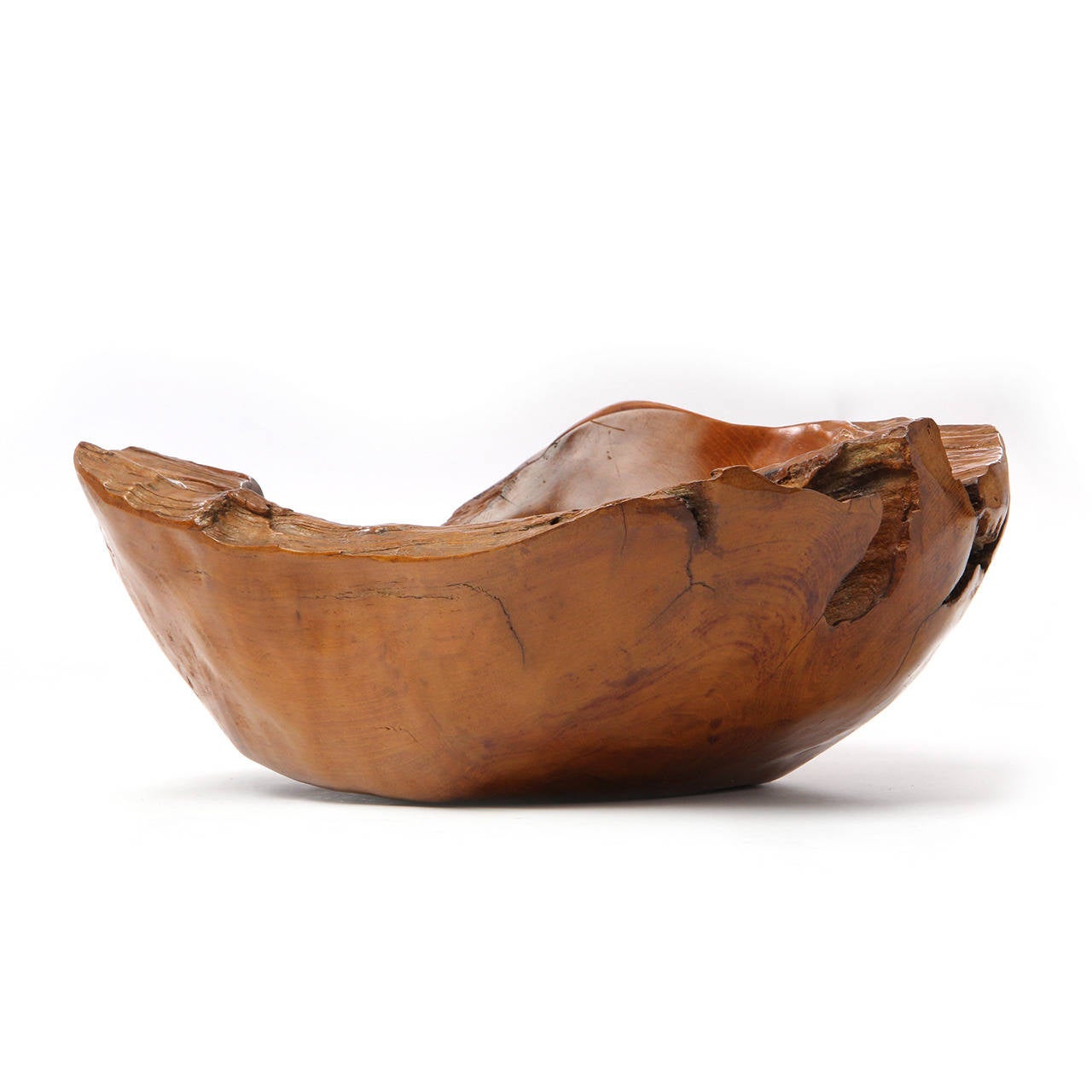A beautiful and expressive hand-carved bowl of great scale having a warm caramel tone and natural free-edge sides.