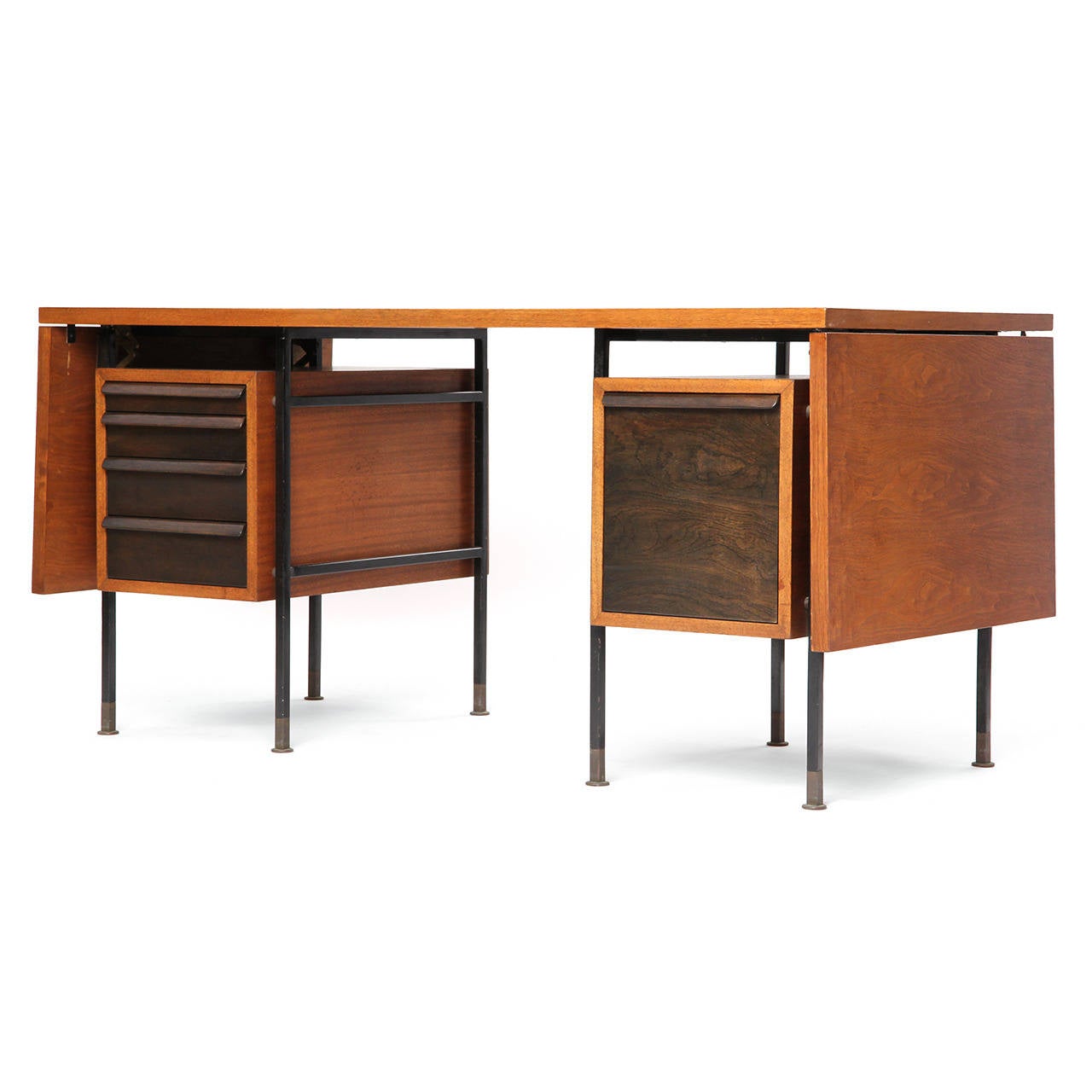 A fine, architectural and uncommon double drop-leaf desk, the figured walnut top hovering above two floating contrasting compartments (with open shelving on the back) suspended within a lacquered metal frame with expressive brass feet.