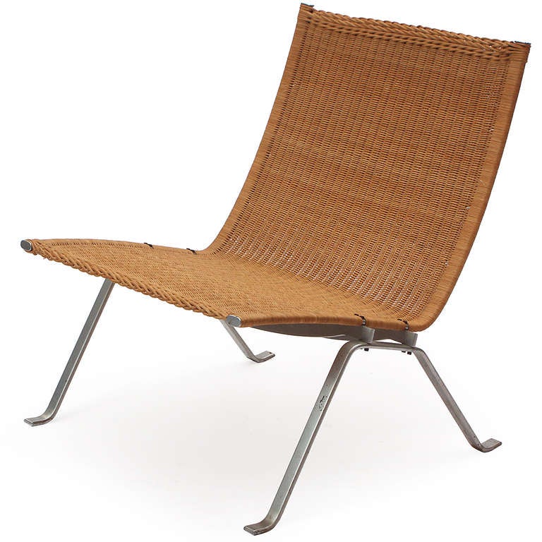 A beautiful early example in brushed steel and rattan of Poul Kjaerholm's majestic minimalist and refined lounge chair.