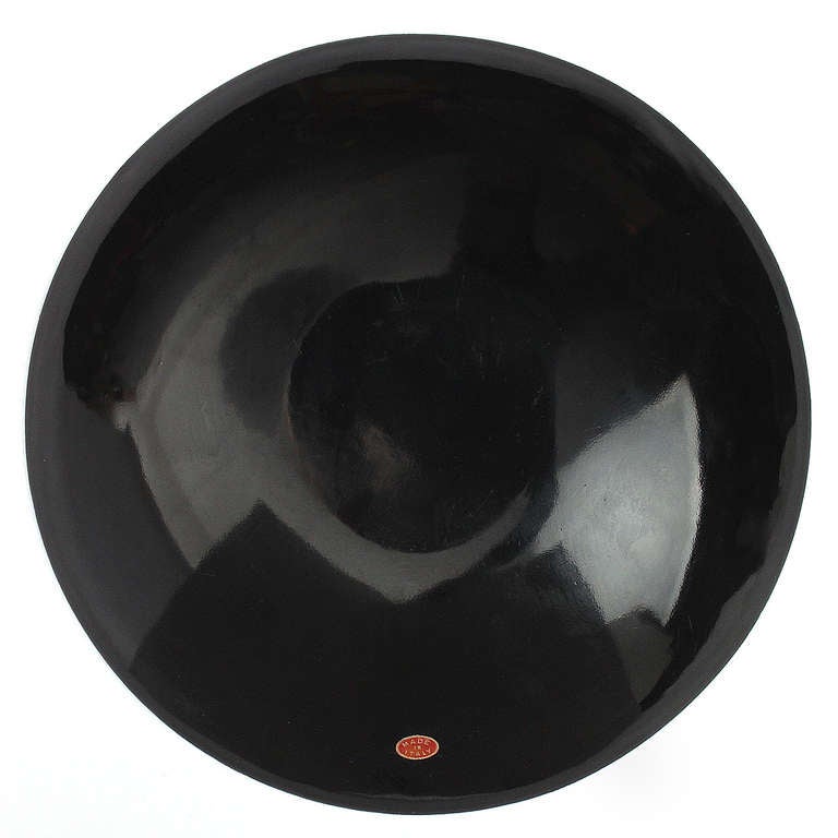 An Italian shallow bowl or charger in porcelain enameled steel with bold graffiti-inspired 'spray painted' decoration.