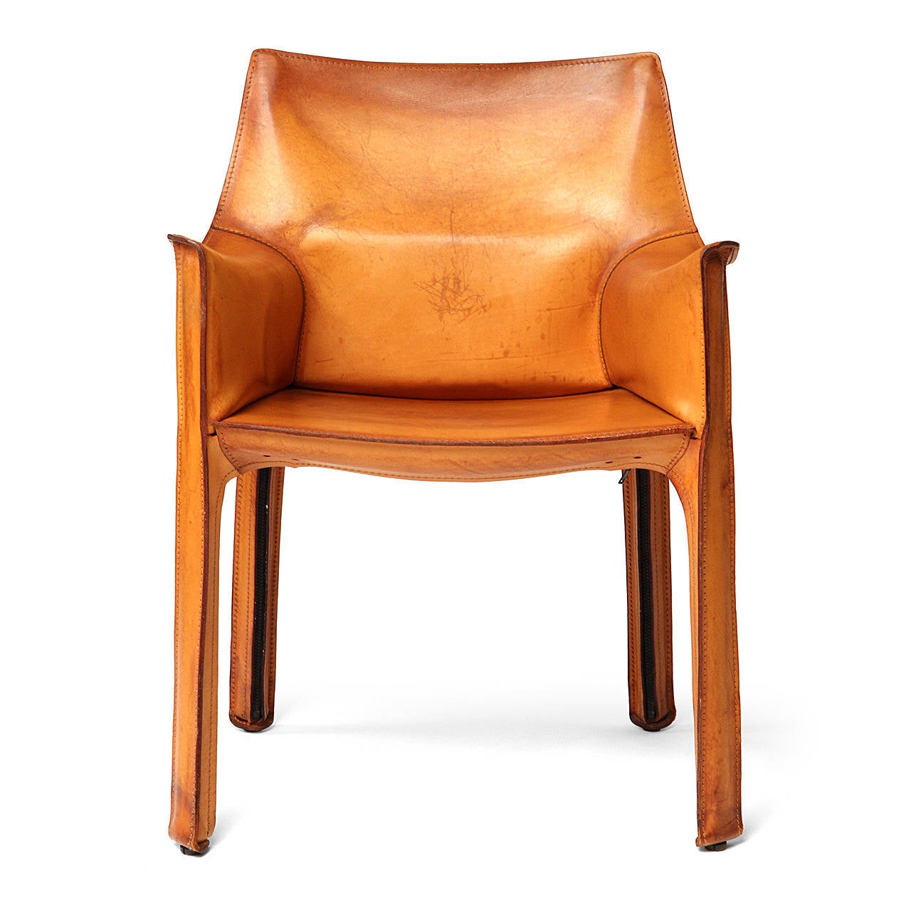 An Italian Mid-Century Modern armchair designed by Mario Bellini featuring handstitched natural leather upholstery wrapped over internal steel frame. Manufactured by Cassina in Italy, circa 1977.