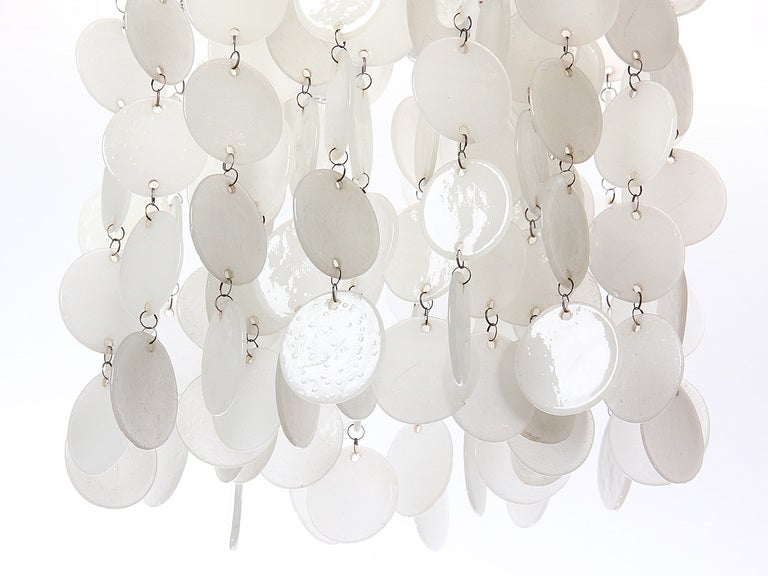 A ceiling fixture with suspended glass discs.