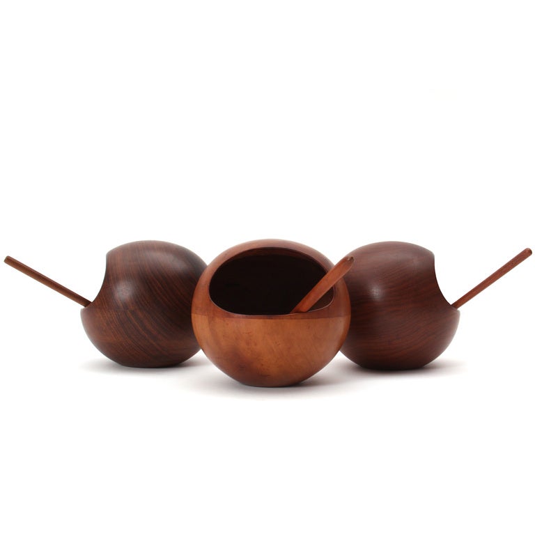 Your choice of three hand turned spherical teak nut bowls with an oval opening and the original spoon. Two are stamped 
