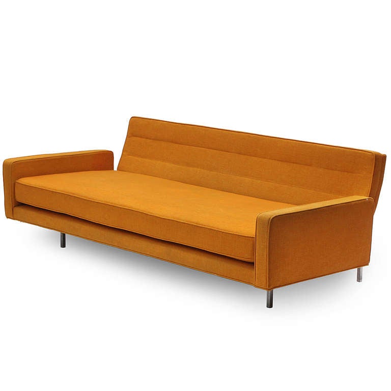 A classic and well-crafted International Style daybed/sofa of strong rectilinear form having a fully upholstered seating element in a burnt Sienna wool floating on a geometric square gauge steel frame