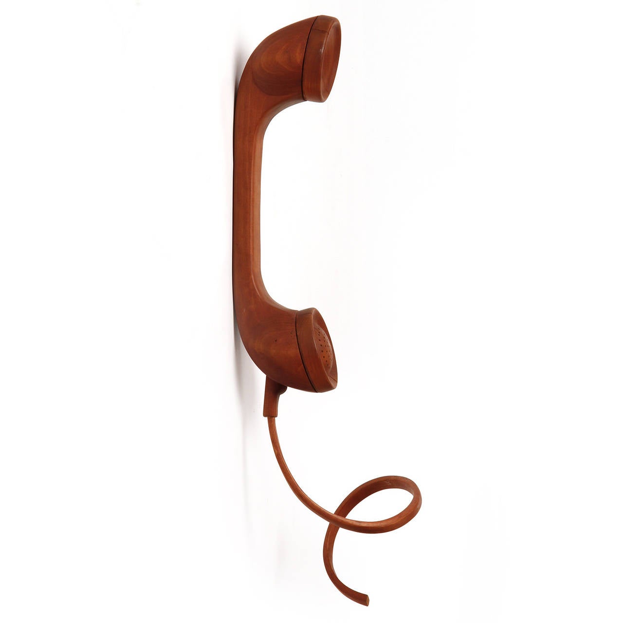 An amazing large-scaled wall-mounted Pop Art sculpture of a telephone with cord beautifully carved from a solid blank of wood.