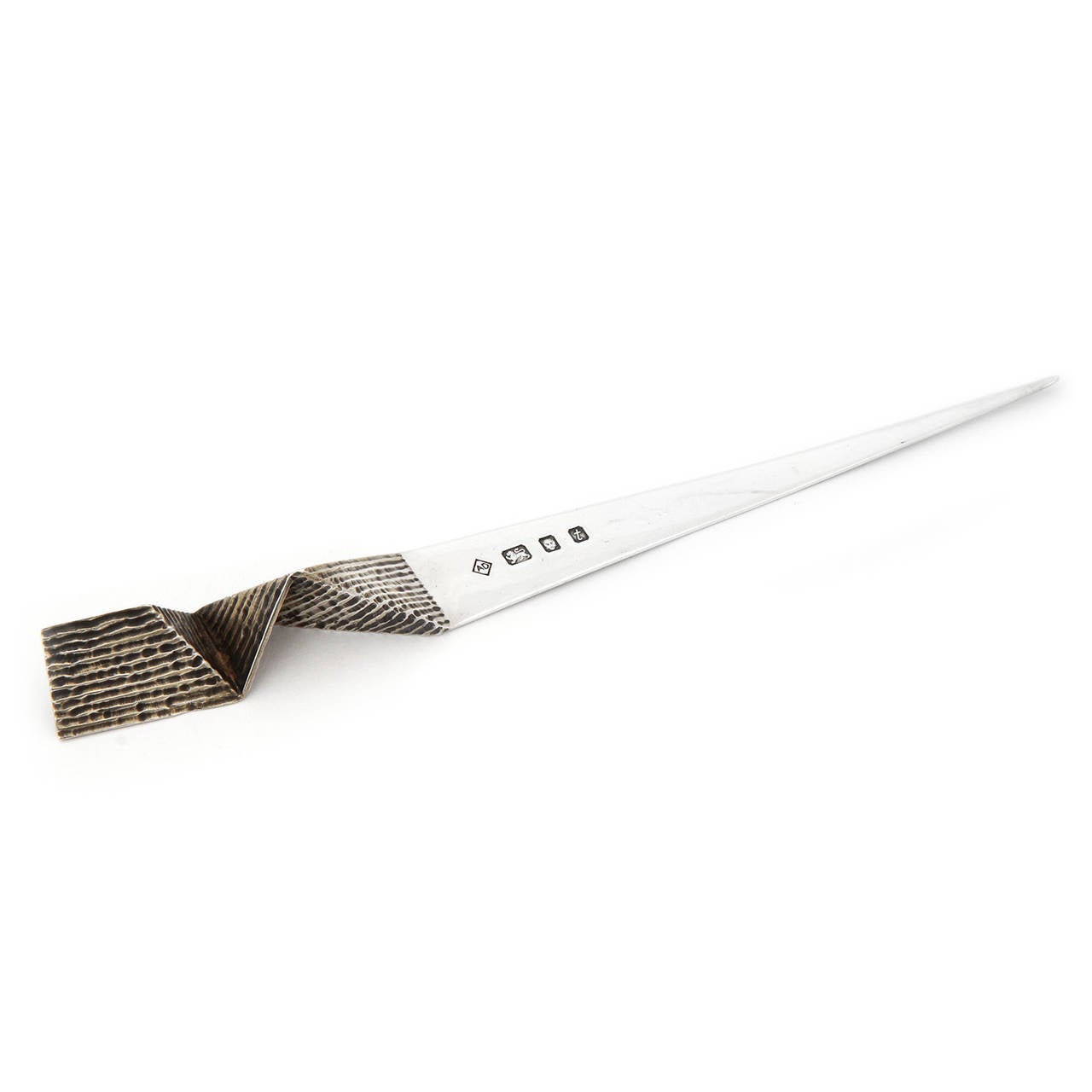 A beautiful and fully hallmarked modernist sterling silver letter opener by Alfred Dunhill. The letter opener features an expressive angled handle with gilding and striation.