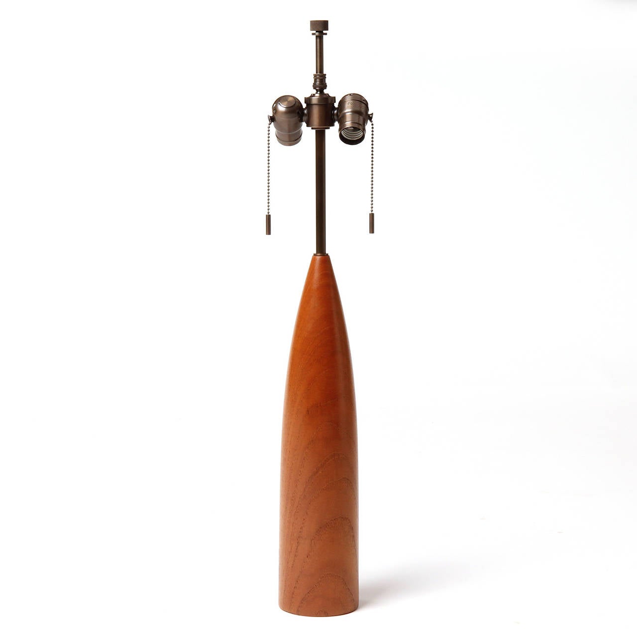 A sculptural and elegant table lamp, turned from a solid piece of teak.