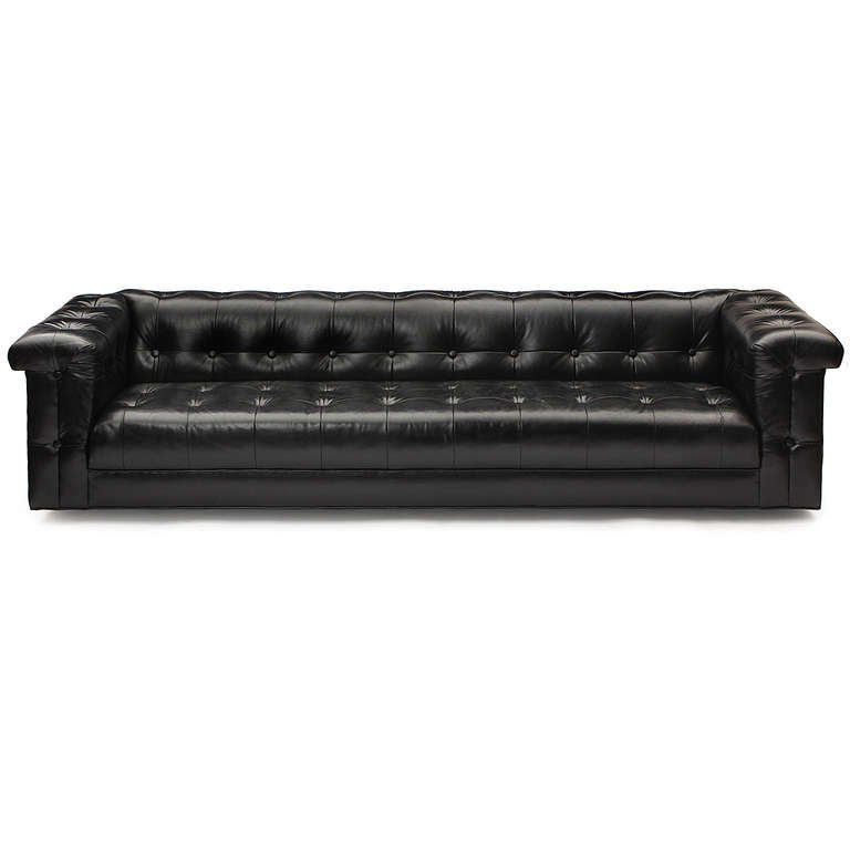 A generously proportioned and highly comfortable Chesterfield sofa with full button tufted upholstery in its excellent original black leather.