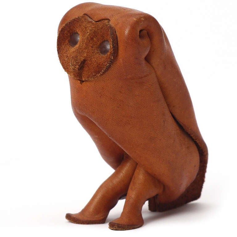 A whimsical and expressive owl crafted of folded and cut natural leather.