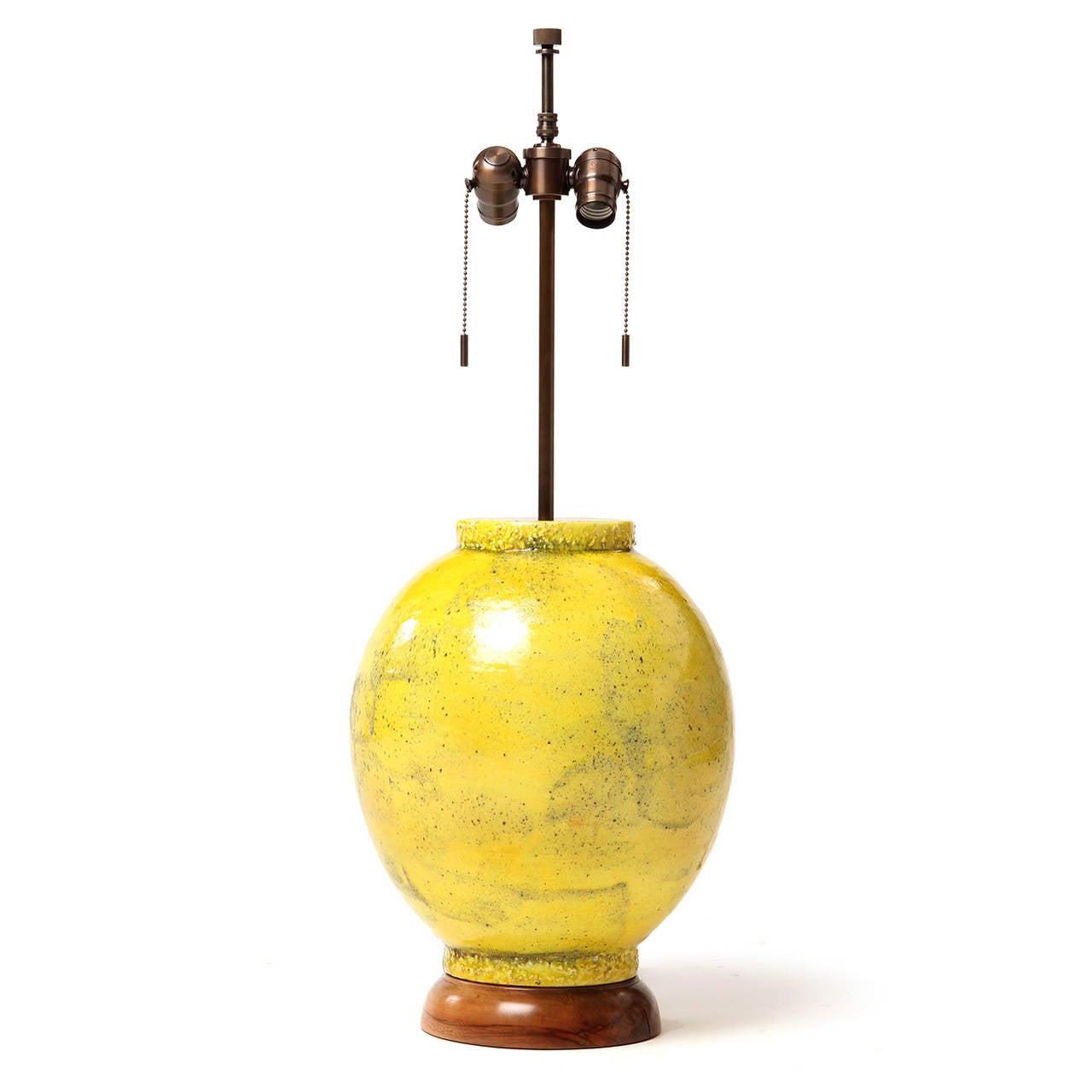A hand-thrown and well-scaled ceramic table lamp having a baluster form with a  distinctive textured top and bottom rim; the whole lamp covered in a rich smoky yellow glaze with mocha undertones.