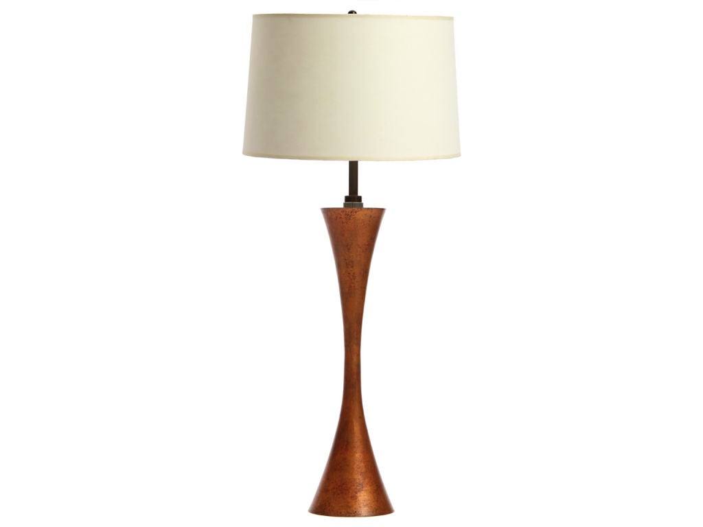 A pair of table lamps with a copper finish in the form of a concave column. Shades not included.